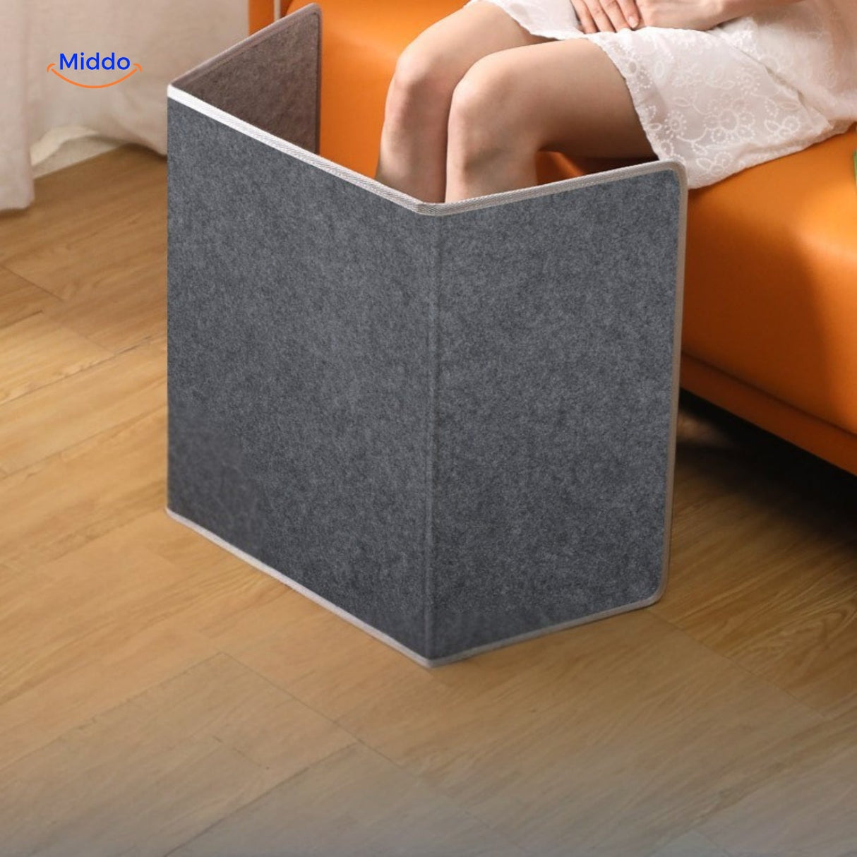 coussin chauffant pour jambes en utilisation sur le canapé, confort hivernal