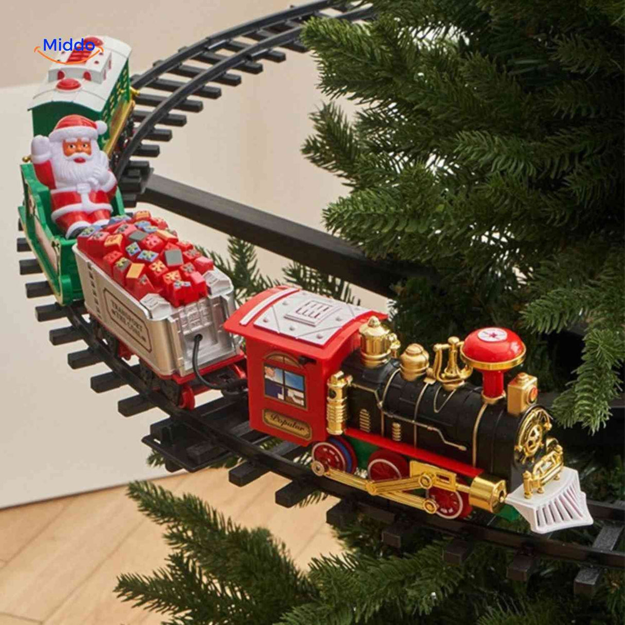 train de noël sur circuit circulaire avec wagons autour du sapin