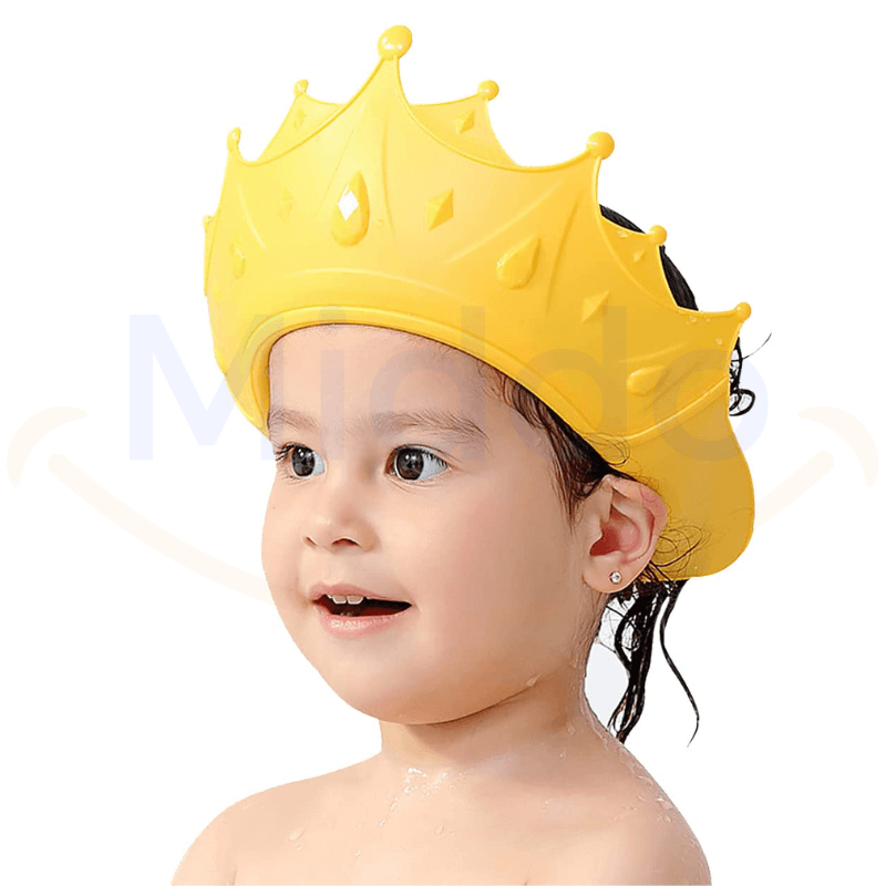 enfant portant un bonnet de douche en forme de couronne jaune pour se protéger les yeux