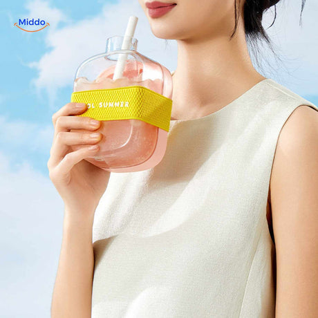 bouteille à glaçons rose portée en bandoulière avec boisson estivale, gros plan lifestyle