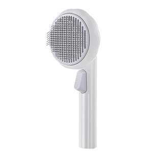brosse autonettoyante pour chat en coloris blanc avec poils massants et bouton d'éjection