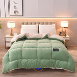 couverture pondérée en laine veloutée coloris vert présentée sur lit, fond blanc