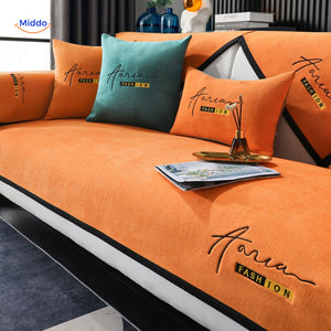 housse de canapé coloris orange et vert, idéale pour apporter une touche vive