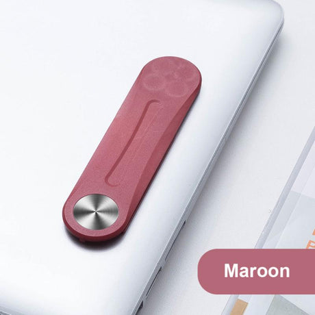 clip magnétique couleur bordeaux fixé sur un ordinateur portable pour tenir le téléphone