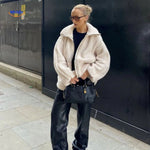 manteau en laine teddy beige porté dans un escalier, style cosy chic