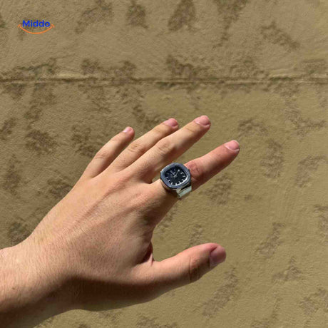 montre-bague argent avec cadran noir portée sur une main, accessoire élégant
