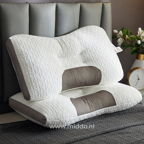 oreiller soutien nuque ergonomique posé sur un lit fait dans une chambre apaisante