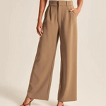 pantalon large femme brun avec deux poches latérales, porté avec des mules à talons