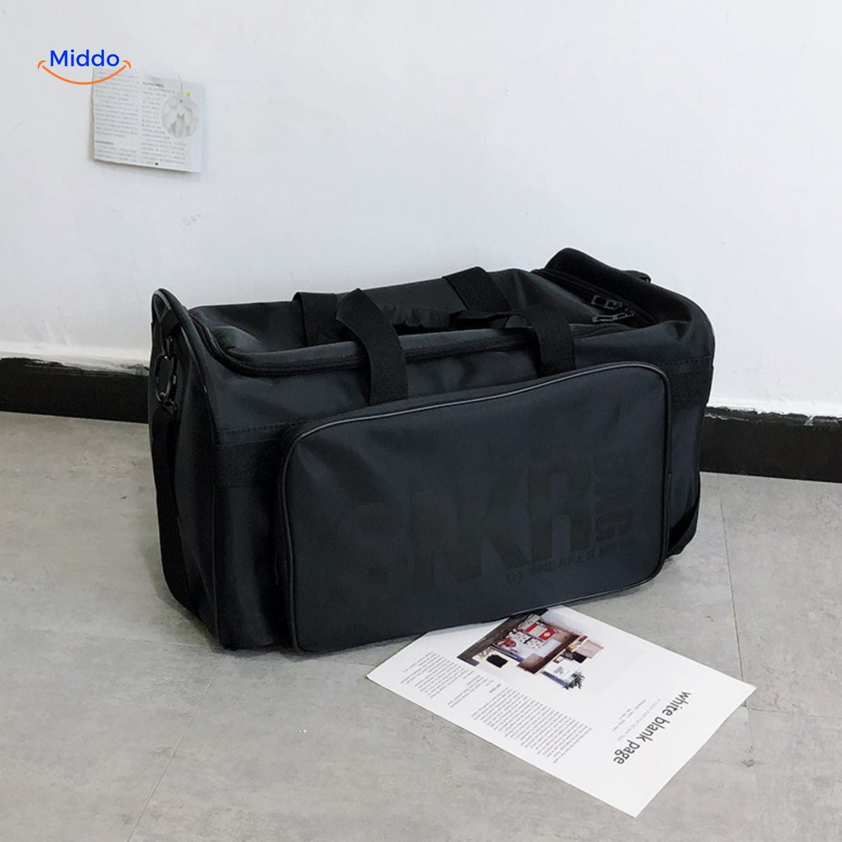 sac de voyage noir avec texte gris clair discret sur la face avant