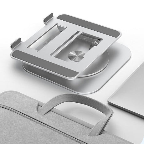 support pliable pour ordinateur portable posé à côté d'un sac sur une surface blanche