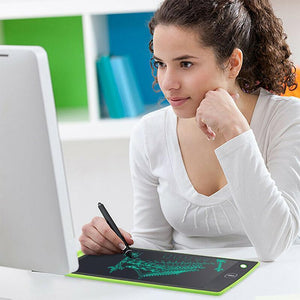 femme utilisant une tablette lcd d'écriture mince et légère à côté de son ordinateur