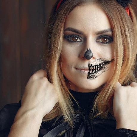 tatouage horreur tête de mort avec sourire sinistre sur le visage d'une femme pour halloween