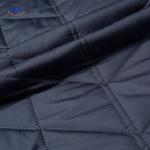 détail de la texture matelassée avec piqûres régulières de la veste homme